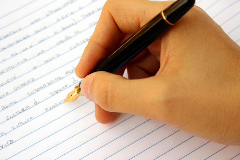 Image of pen and paper illustrating grant consulting services including grant writing and critiquing.